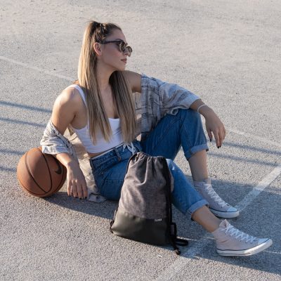 Young girl with Drawstring Bag and a basketball